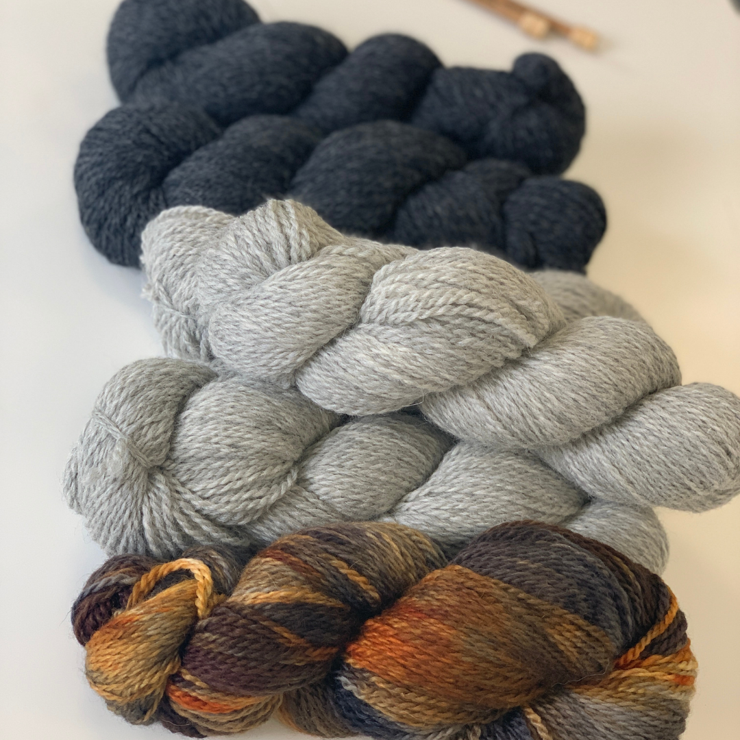 British yarn, hand painted, yarn for hand knitting. Knitting patterns and sustainable yarns by Jo Storie. Front to back Tarmachan, Silver Birch grey and Charcoal grey